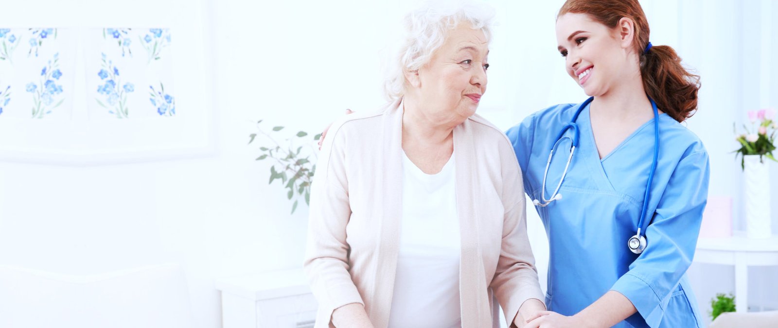 nurse and elderly women in light room